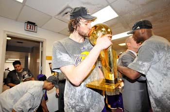 ORLANDO, FL - JUNE 14:  Pau Gasol #16 of the Los Angeles Lakers celebrates with the Larry O'Brien Championship trophy after the Lakers won 99-86 to win the NBA Championship against the Orlando Magic in Game Five of the 2009 NBA Finals at Amway Arena on June 14, 2009 in Orlando, Florida. NOTE TO USER: User expressly acknowledges and agrees that, by downloading and or using this photograph, User is consenting to the terms and conditions of the Getty Images License Agreement. Mandatory Credit: 2009 NBAE  (Photo by Jesse D. Garrabrant/NBAE/Getty Images)